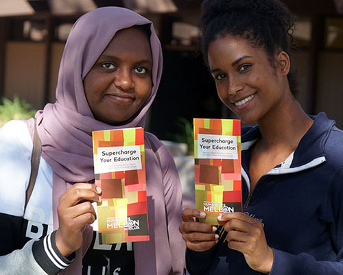 two female students holding brochure